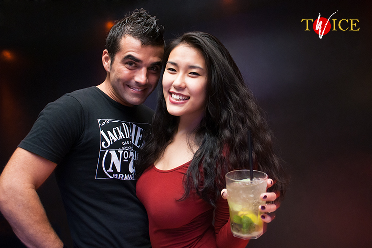 # Twice Club. A pretty couple with powerful drinks. A whiskey and mohito embrace.
