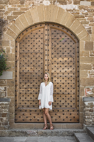 # Ulisse Albiati Photographer: deadly model in a location shooting, in front of an ancient main door. Cathedral of San Miniato al Monte in Florence, Tuscany.