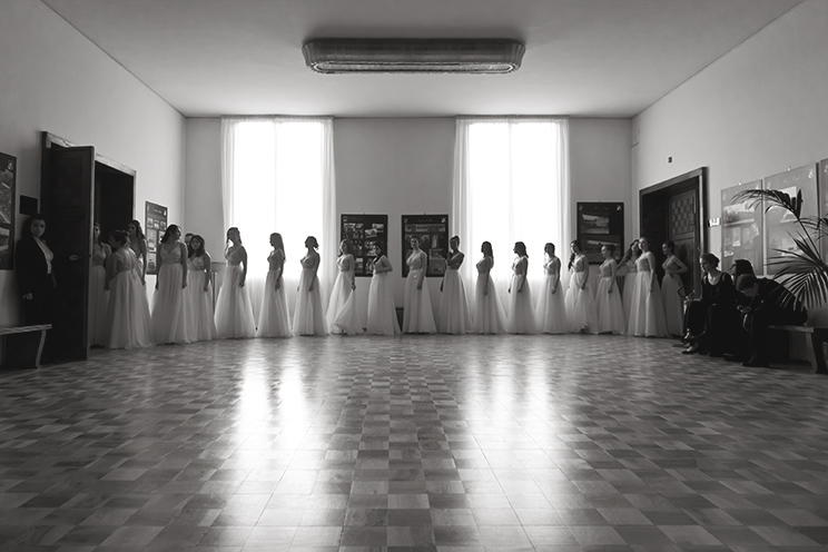 # Ulisse Albiati Photographer: a debutante dress is a white ball gown, worn by novices at their first formal dance party. Debutante ball, Italian Air Force theater in Florence, Tuscany.